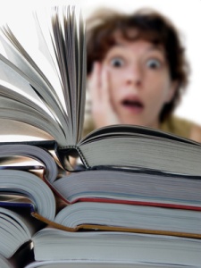 terrified woman behind a big pile of books